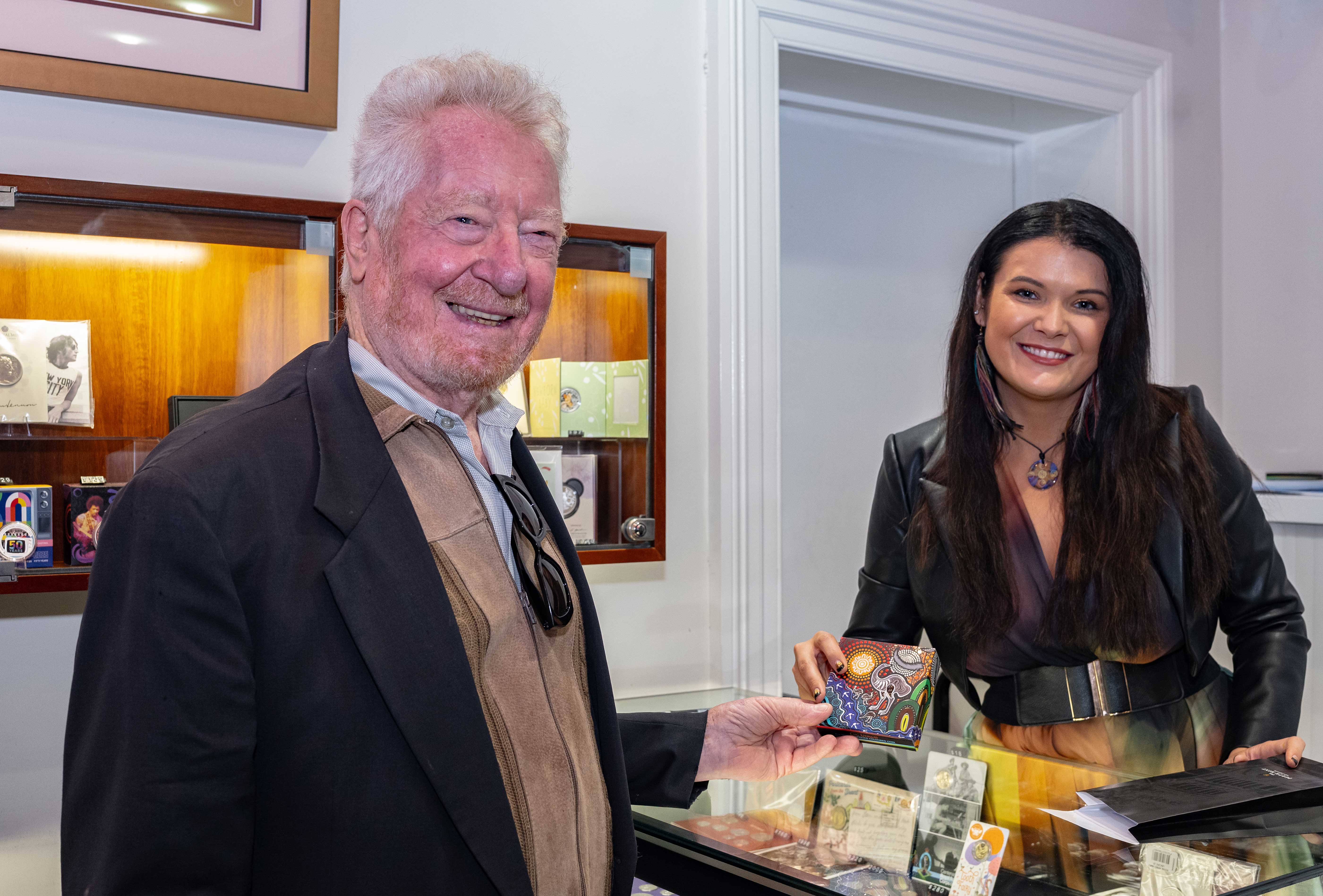 Indigenous artist, Chern'ee Sutton signs coin certificates for customers